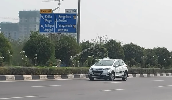 Kollur Junction Connectivity Highway signage at Kollur Junction near Prestige Golden Grove showing ORR directions to Bengaluru and Vijayawada