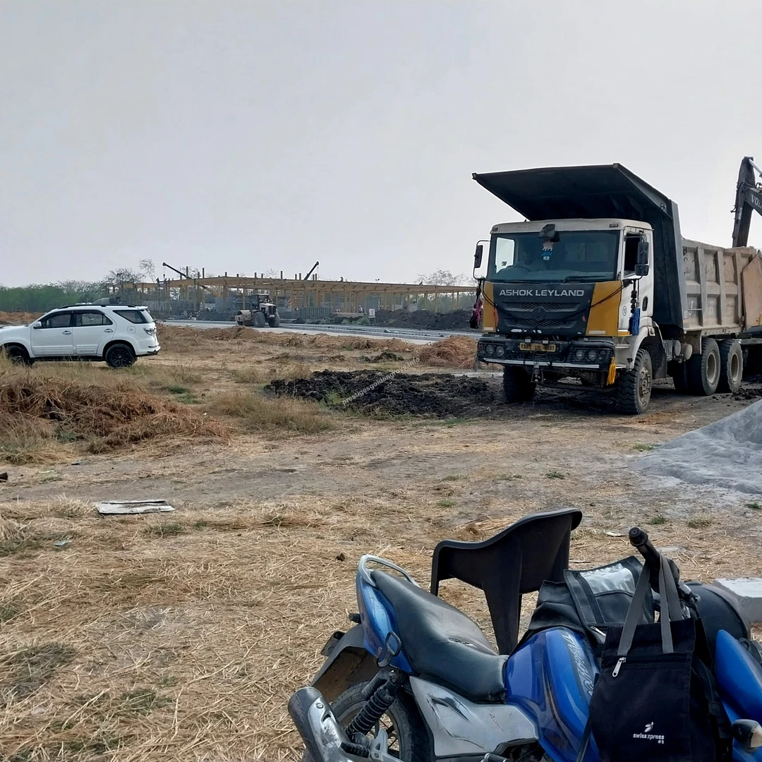 Material Transport A large dump truck and excavator working together to transport construction materials at the Prestige Golden Grove site