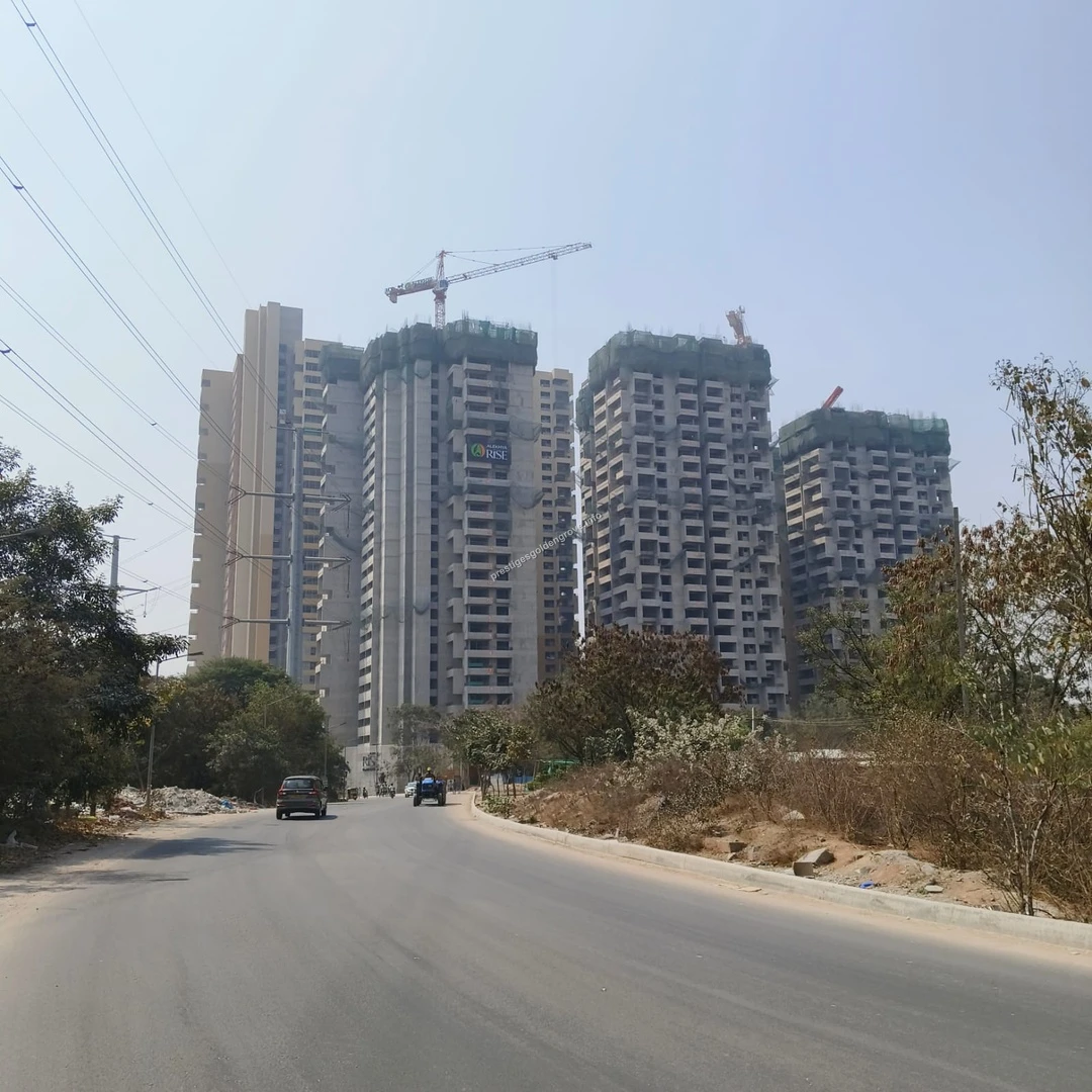 Neighborhood Development Street view of the expanding neighborhood featuring the Alekhya Rise project and wide access roads near Prestige Golden Grove
