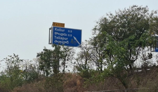 ORR Exit Signage Clear highway signage indicating Exit 02 for Kollur and Tellapur, demonstrating the seamless Outer Ring Road connectivity to the Prestige Golden Grove project